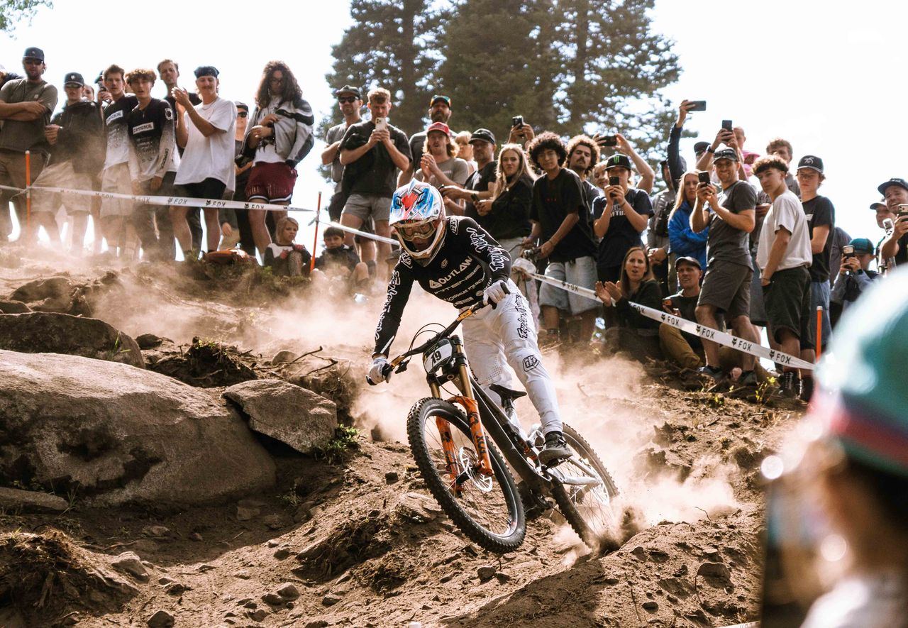 Fred drifting through dust in front of a packed crowd of spectators